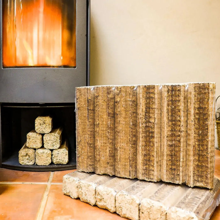 Calido Fire Log Briquettes in front of a stove