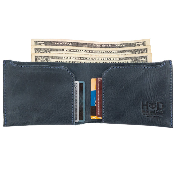 Close-up of the navy blue Hide & Drink Classic Wallet with cards inside, illustrating its capacity as a convenient card organizer. Classic Wallet, Card Organizer, Money Holder, Vintage Pocket, Travel Accessories, Full Grain Leather, StockyardX, Small Batch Production, Hand Cut, Hand Sewn, Fire Branded, Artisan, Handmade in La Antigua Guatemala & Oaxaca Mexico.