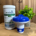 Container of eco3spa water sanitiser tablets and a blue and white hot tub tablet dispenser on a wooden surface with a plant in the background.