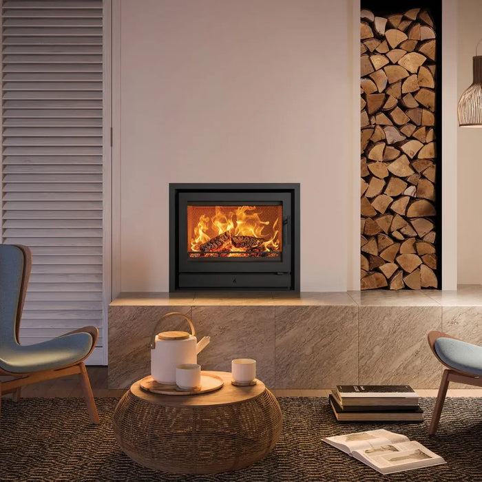 Stovax Riva2 66 Inset Wood Burning Stove - 8.1 kW on cream chimney wall with marble tiles