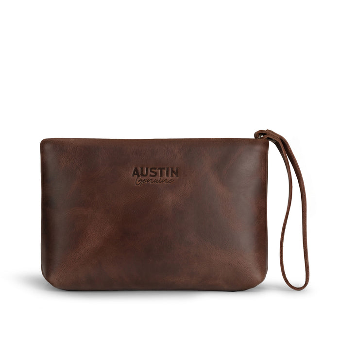 Austin Genuine The Seaholm Makeup Bag, a brown Full Grain Leather wristlet pouch featuring a zip closure and logo; The Seaholm Makeup Bag is made through StockyardX Small Batch Production, Hand Cut, Hand Sewn, Fire Branded, Artisan, Handmade in La Antigua Guatemala & Oaxaca Mexico.