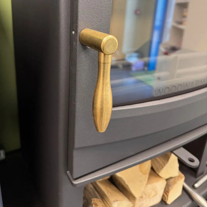 Close-up of black Woodwarm machined teardrop handle on wood burning stove